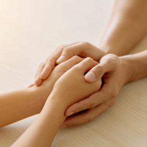 Close-up image of supporting hands of friend